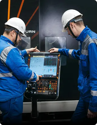 Factory technicians operating production controls