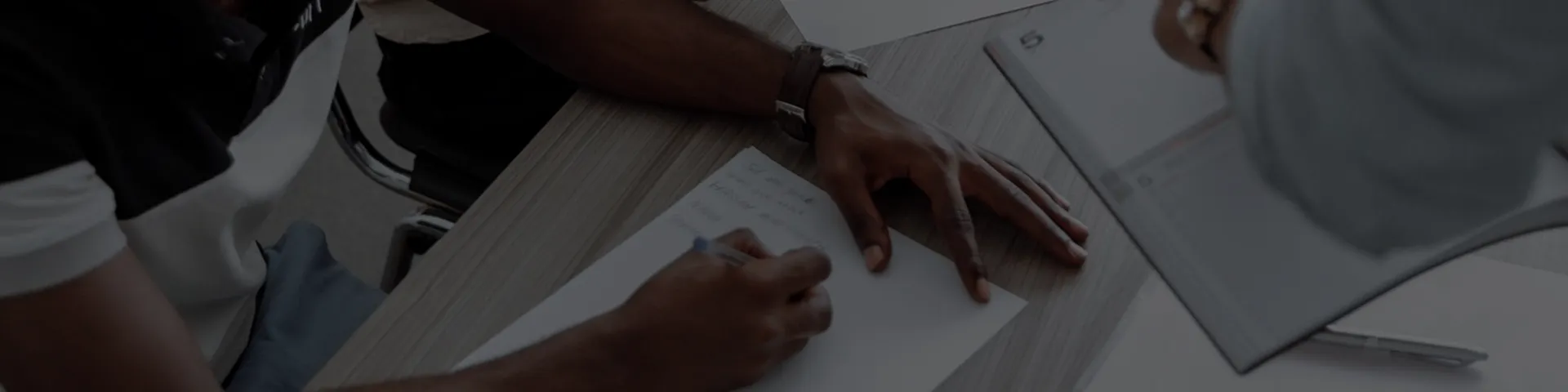 Hands reviewing construction drawings during project planning