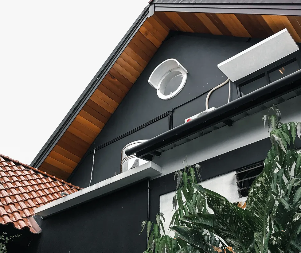 Decorative exterior wall panel installed below a roof eave