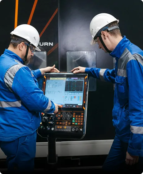 Factory technicians operating panel production controls